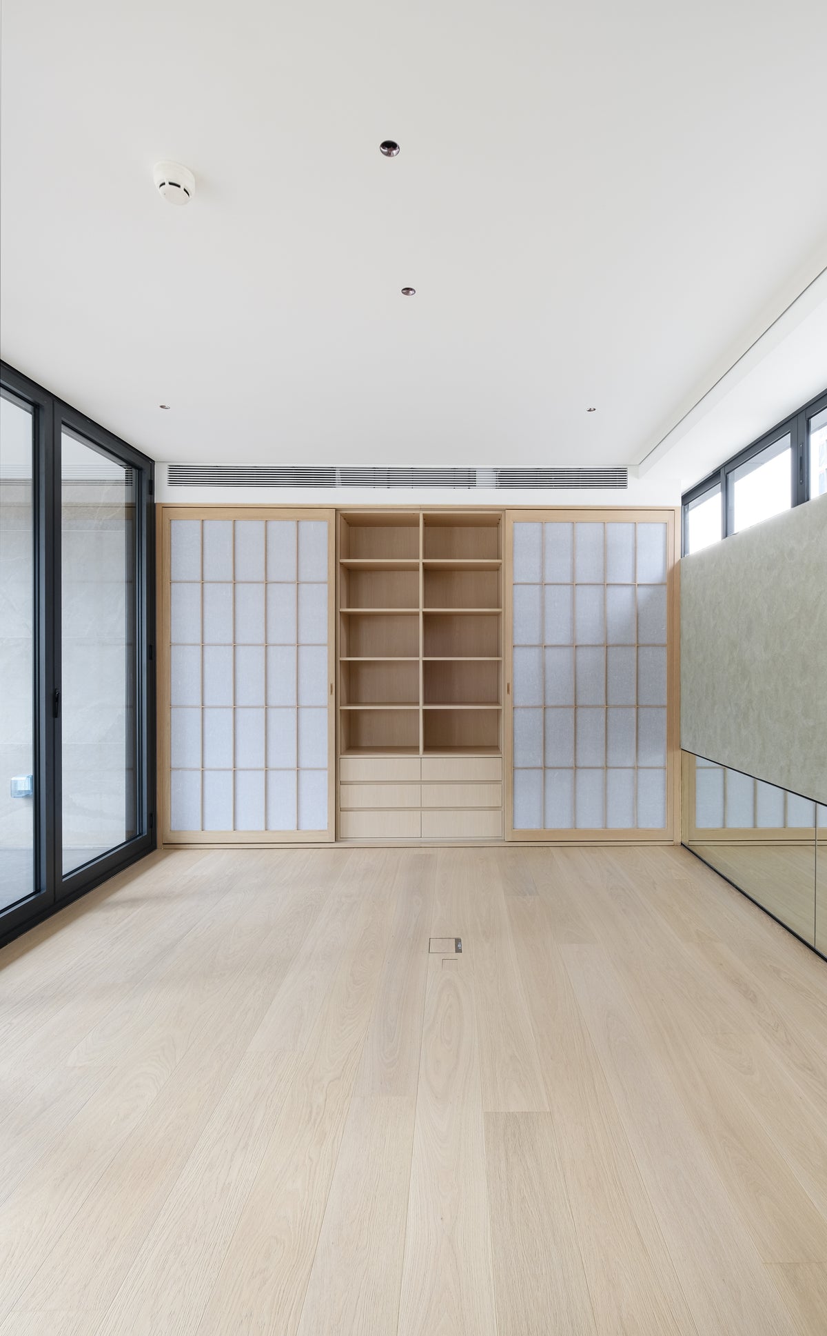 Custom Oak Storage Wall with Translucent Sliding Doors