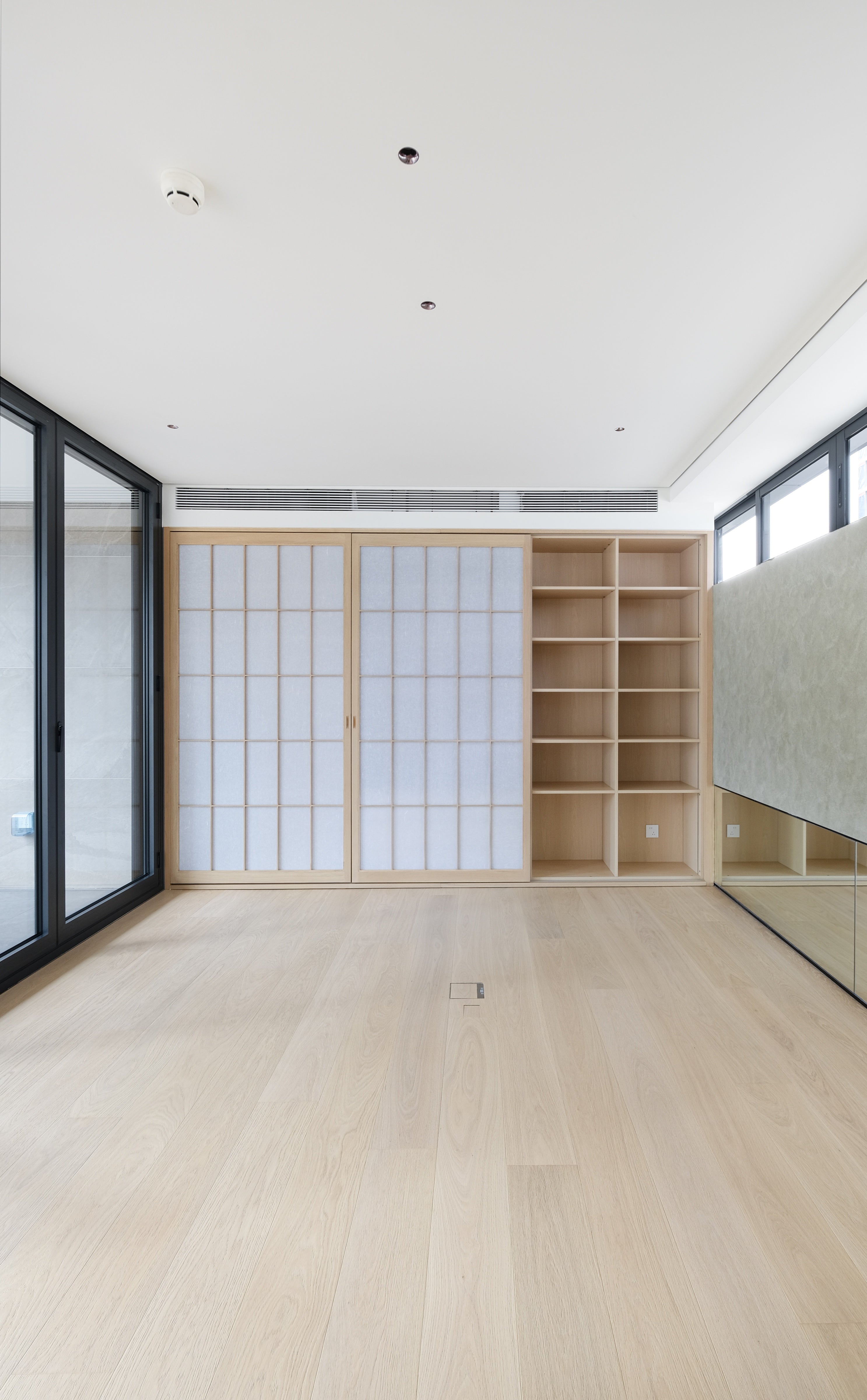 Custom Oak Storage Wall with Translucent Sliding Doors