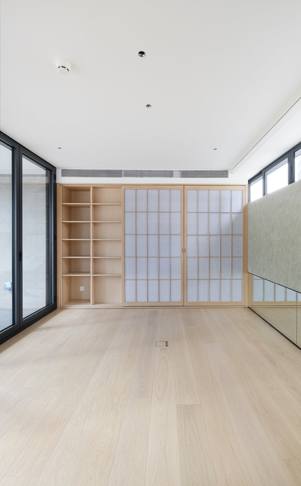 Custom Oak Storage Wall with Translucent Sliding Doors