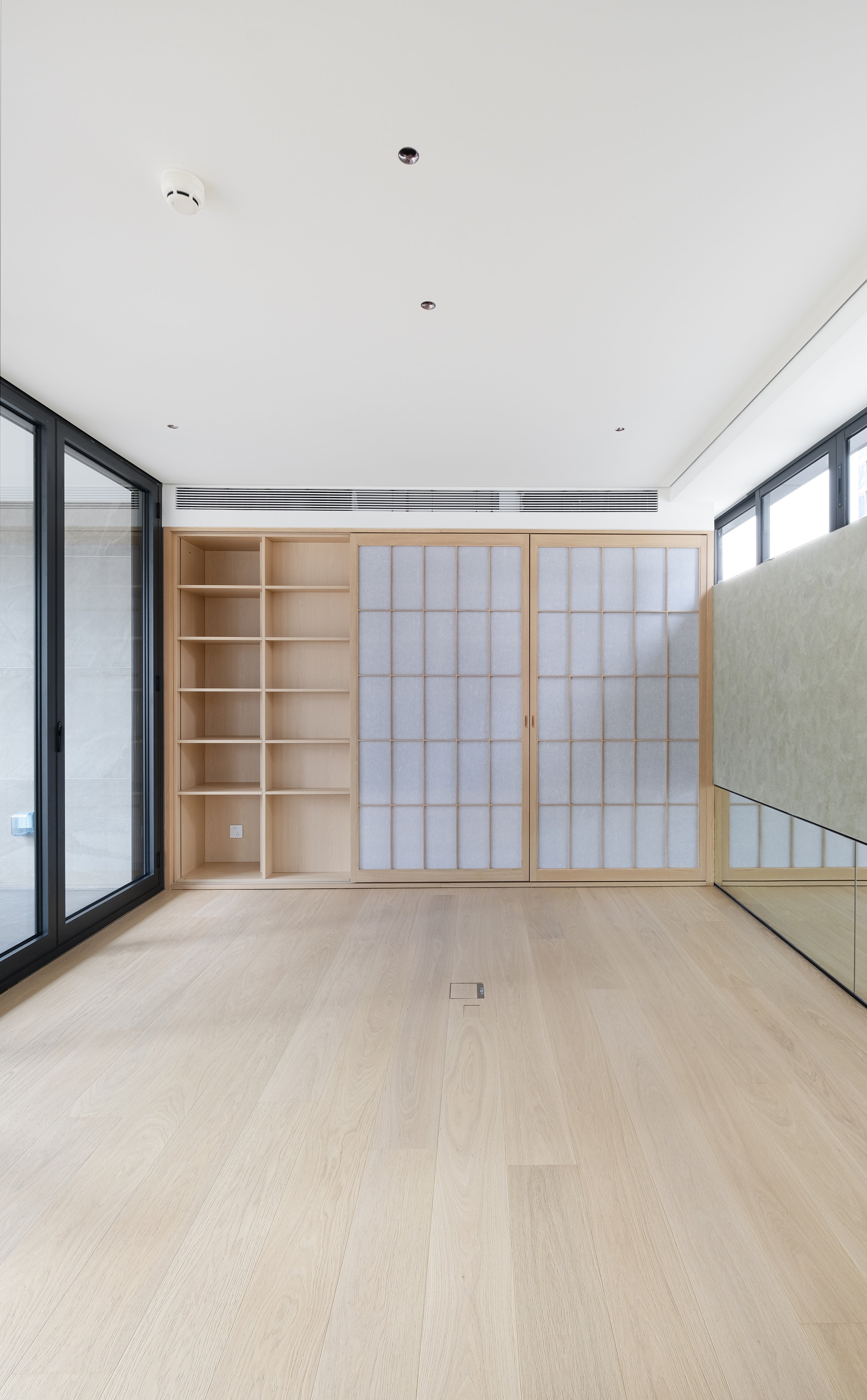 Custom Oak Storage Wall with Translucent Sliding Doors