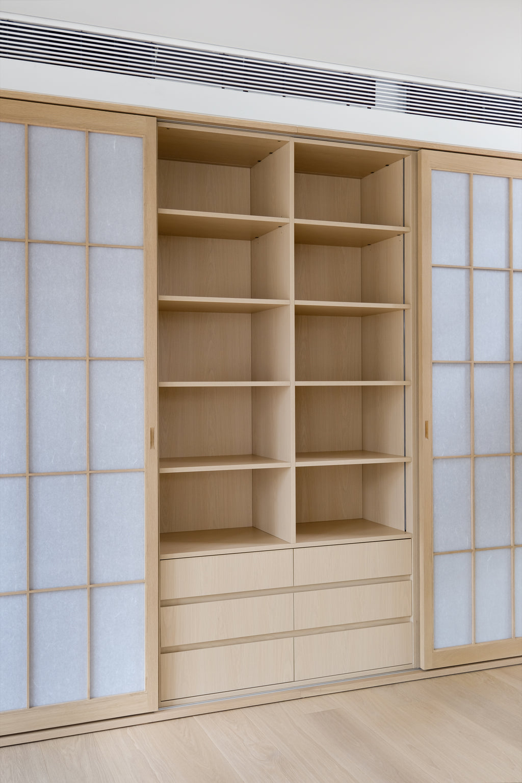 Custom Oak Storage Wall with Translucent Sliding Doors