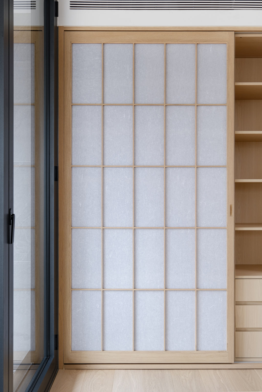 Custom Oak Storage Wall with Translucent Sliding Doors