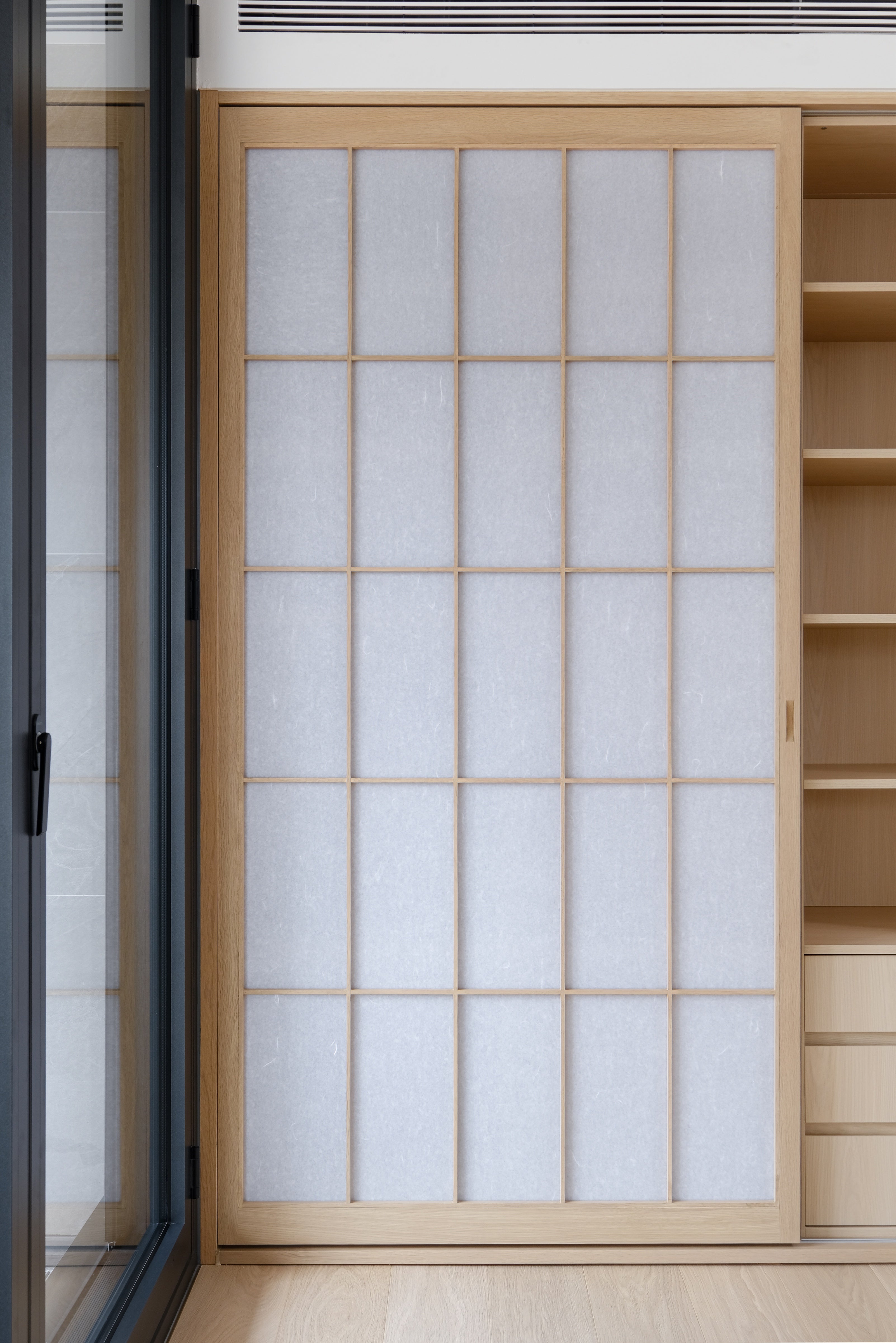 Custom Oak Storage Wall with Translucent Sliding Doors