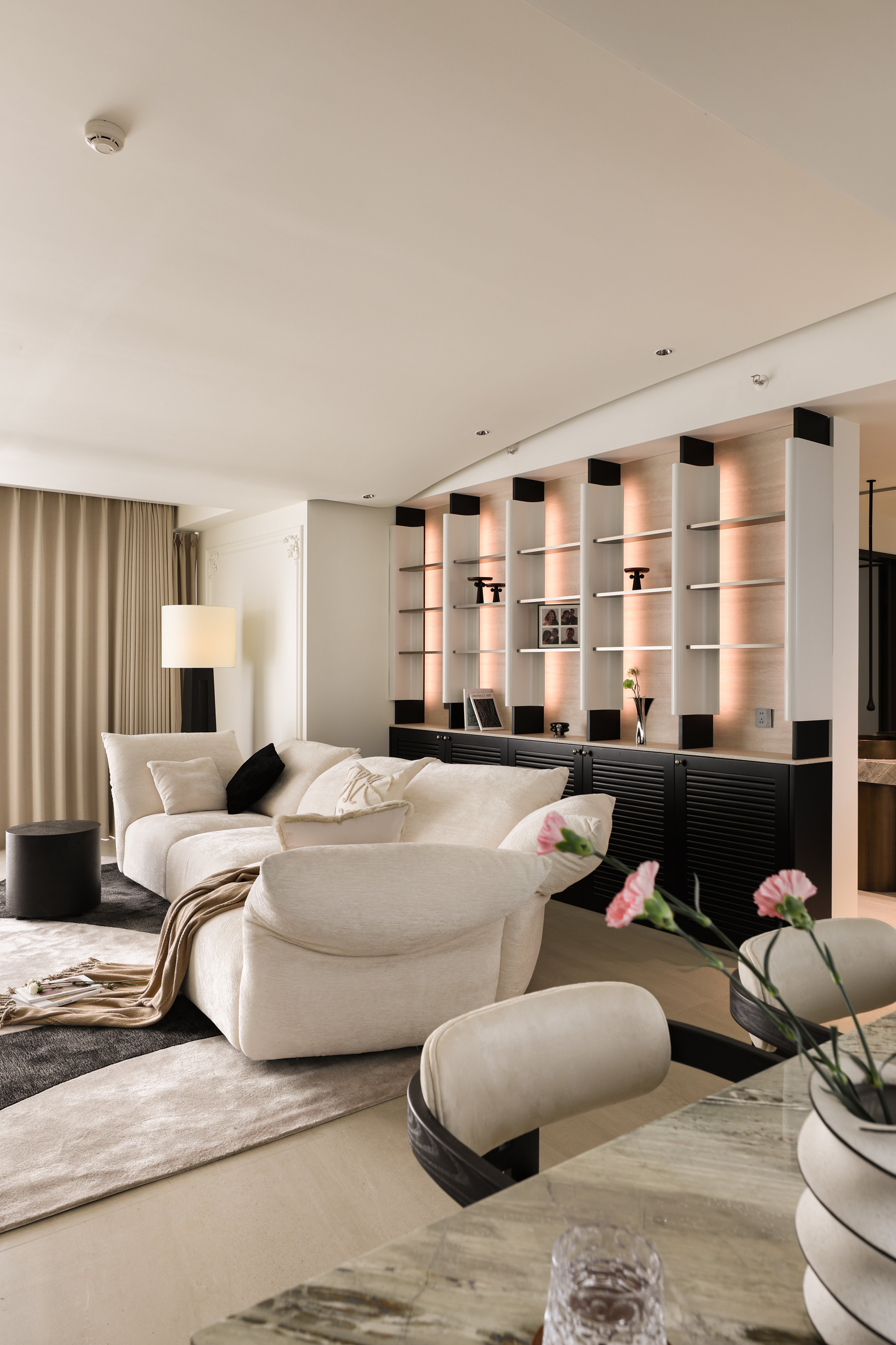 Custom Illuminated Sculptural Shelving Wall with Louvered Base Cabinet