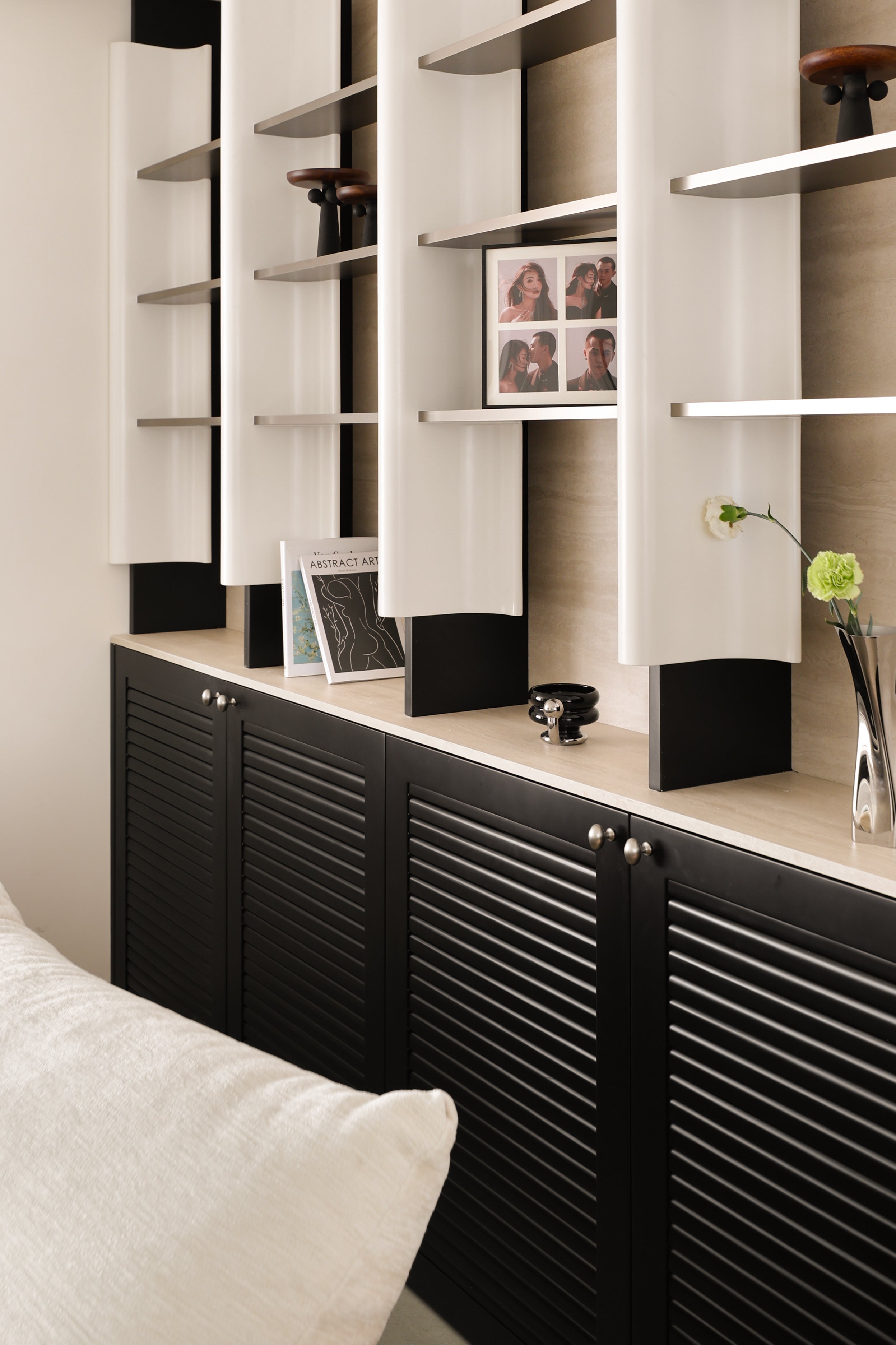 Custom Illuminated Sculptural Shelving Wall with Louvered Base Cabinet