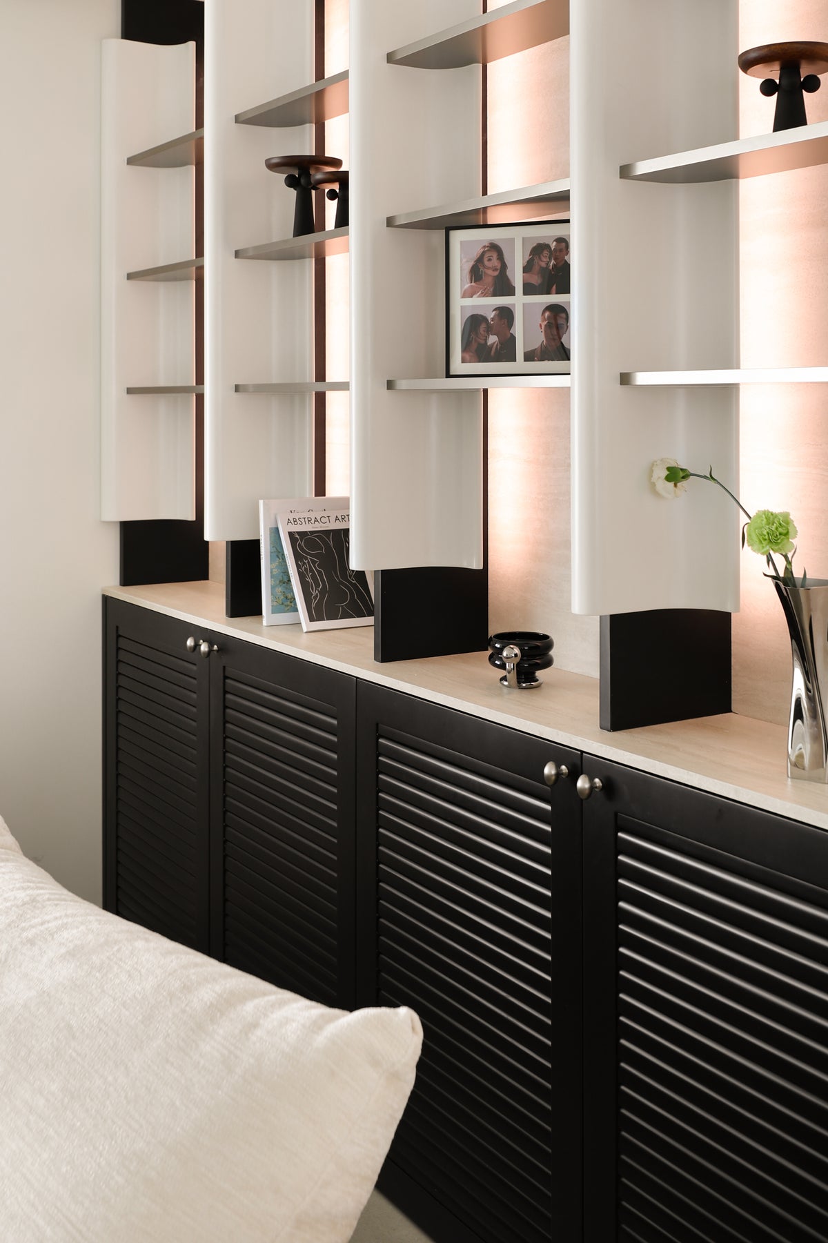 Custom Illuminated Sculptural Shelving Wall with Louvered Base Cabinet