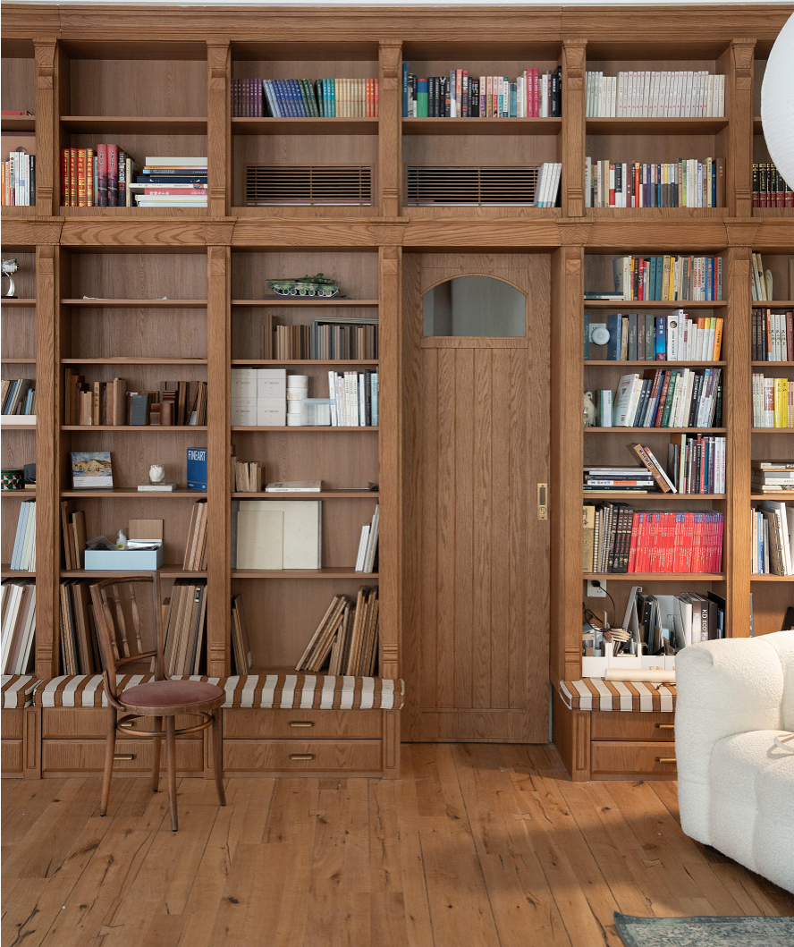 Custom Oak Veneer Library Wall with Integrated Door & Bench Seating